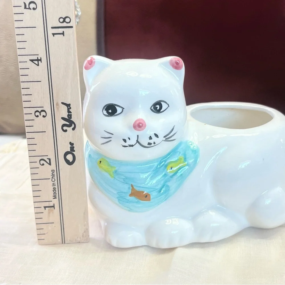 White Ceramic Cat-Shaped Planter with a Blue Scarf Adorned with Fish.